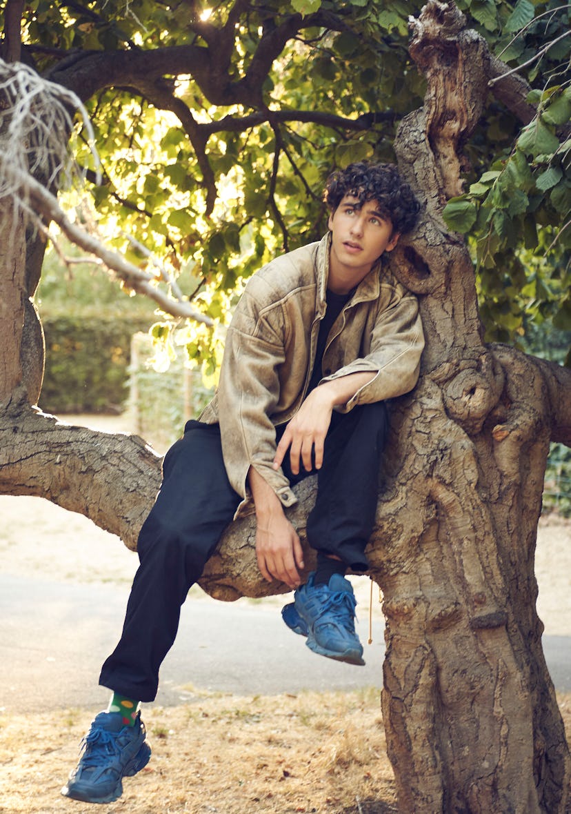 A portrait of Malte sitting in a tree