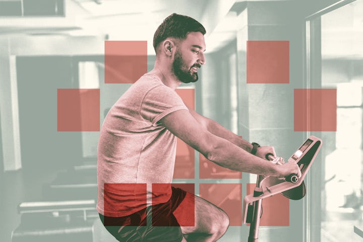 A man doing a cycling workout indoors on a stationary bike.