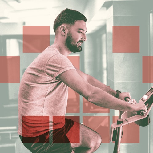 A man doing a cycling workout indoors on a stationary bike.