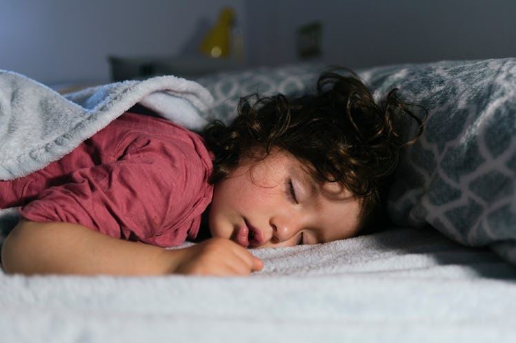 A child sleeping in bed.