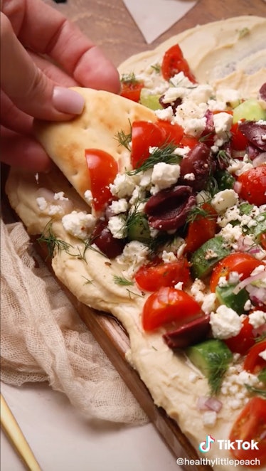 A mediterranean hummus board is a fall hummus board idea  from TikTok for game day or friendsgiving.