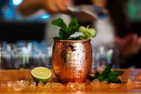 A Moscow Mule cocktail in a frosty copper mug