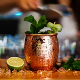 A Moscow Mule cocktail in a frosty copper mug