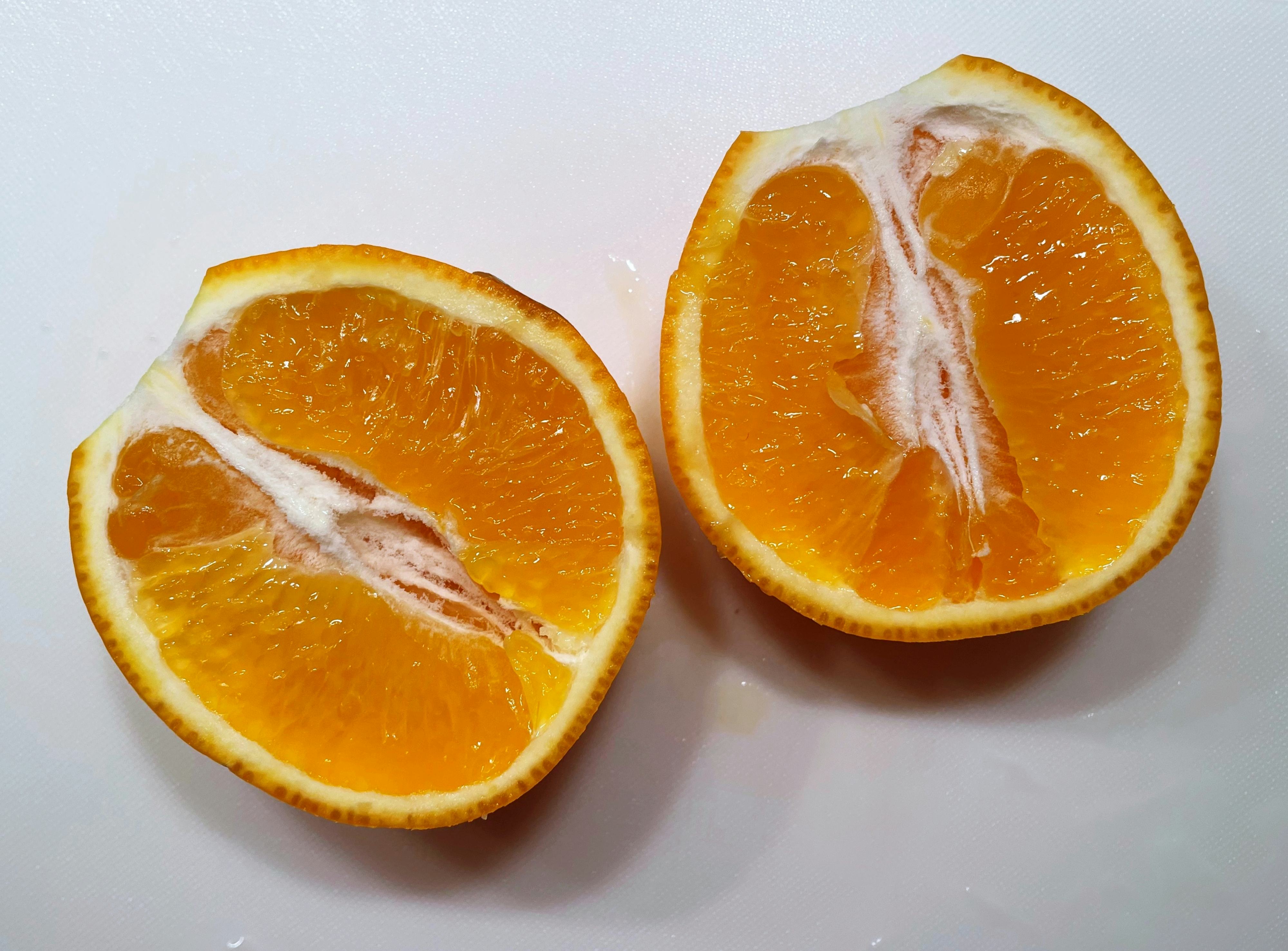Minneola tangelo cut in half.