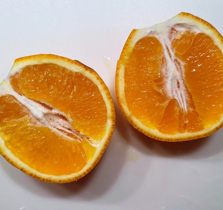 Minneola tangelo cut in half.