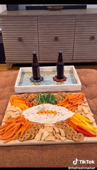 A football hummus board is a fall hummus board idea  from TikTok for game day.