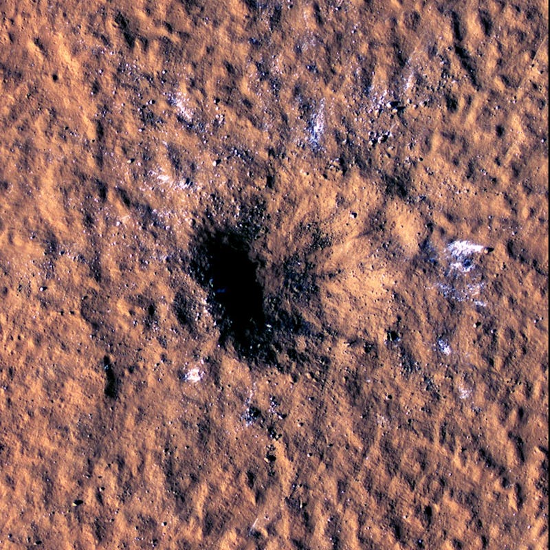 The impact crater, formed Dec. 24, 2021, by a meteoroid strike in the Amazonis Planitia region of Ma...
