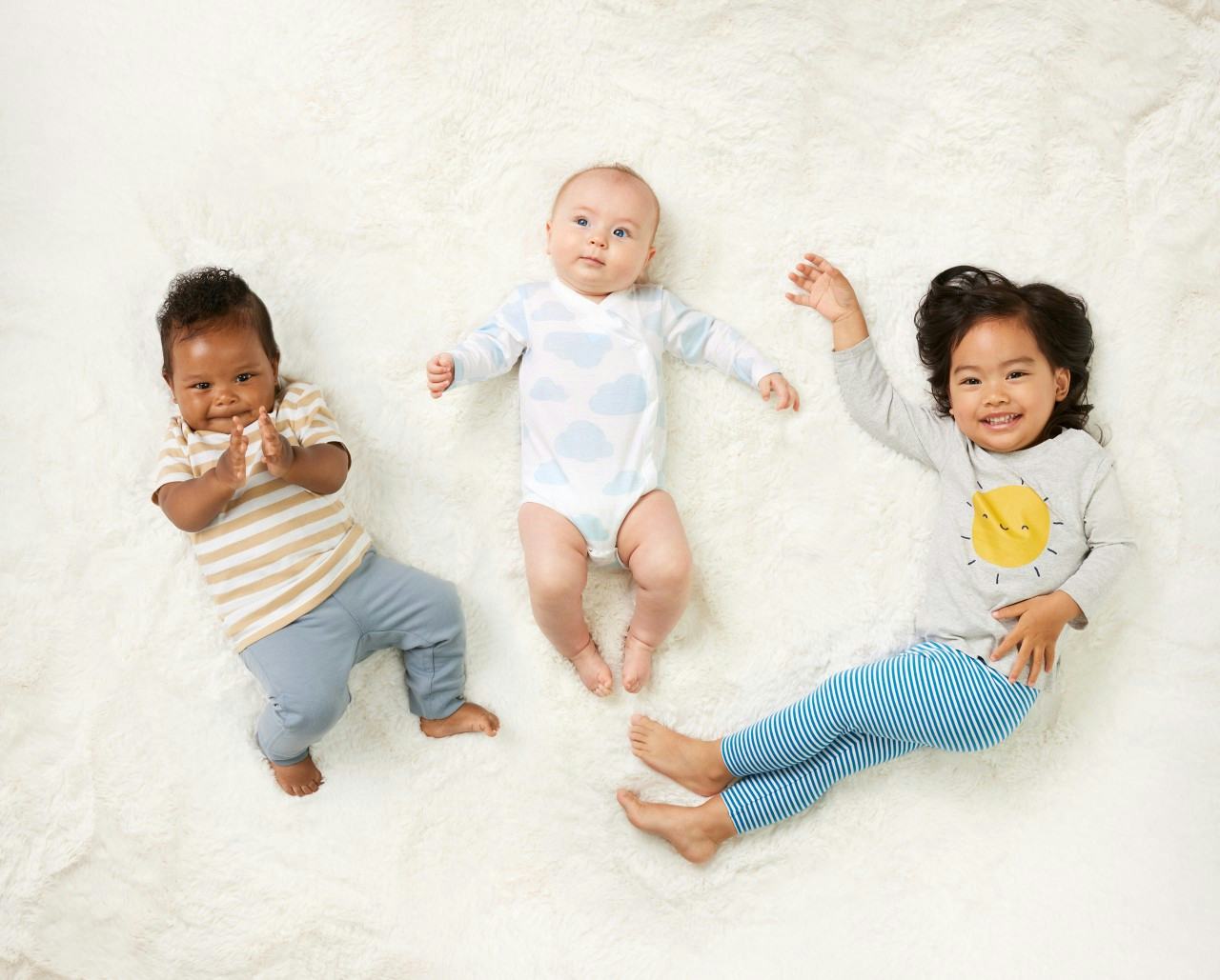 Three children model clothing from the new mighty goods line at buybuy BABY.