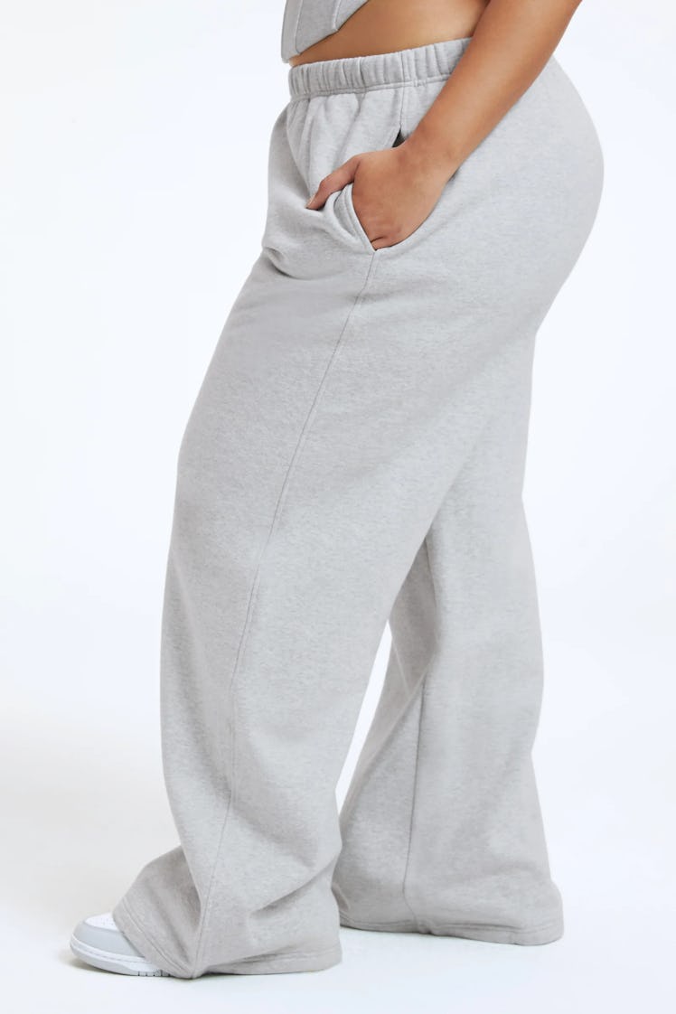 A model wears the grey sweatpants from Good American's Zodiac Collection.