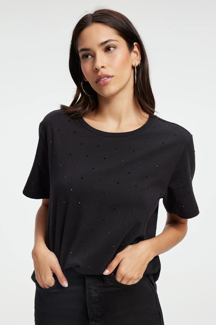 A model wears the black diamond studded tee in Khloe K's Good American Zodiac Collection. 