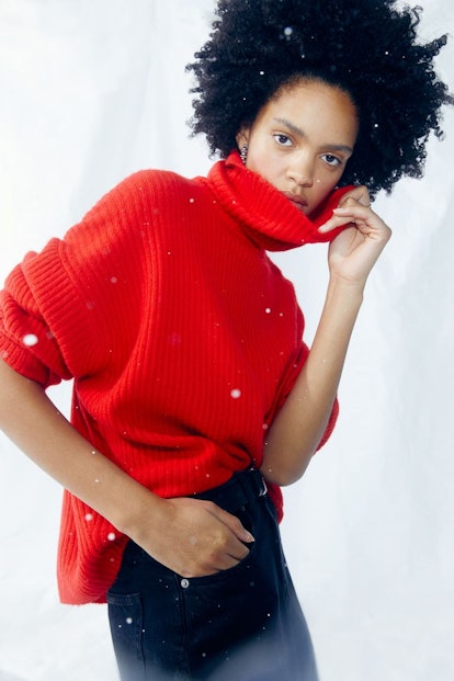A model wearing a red oversized turtleneck sweater which will be 50% off during H&M's Black Friday 2...