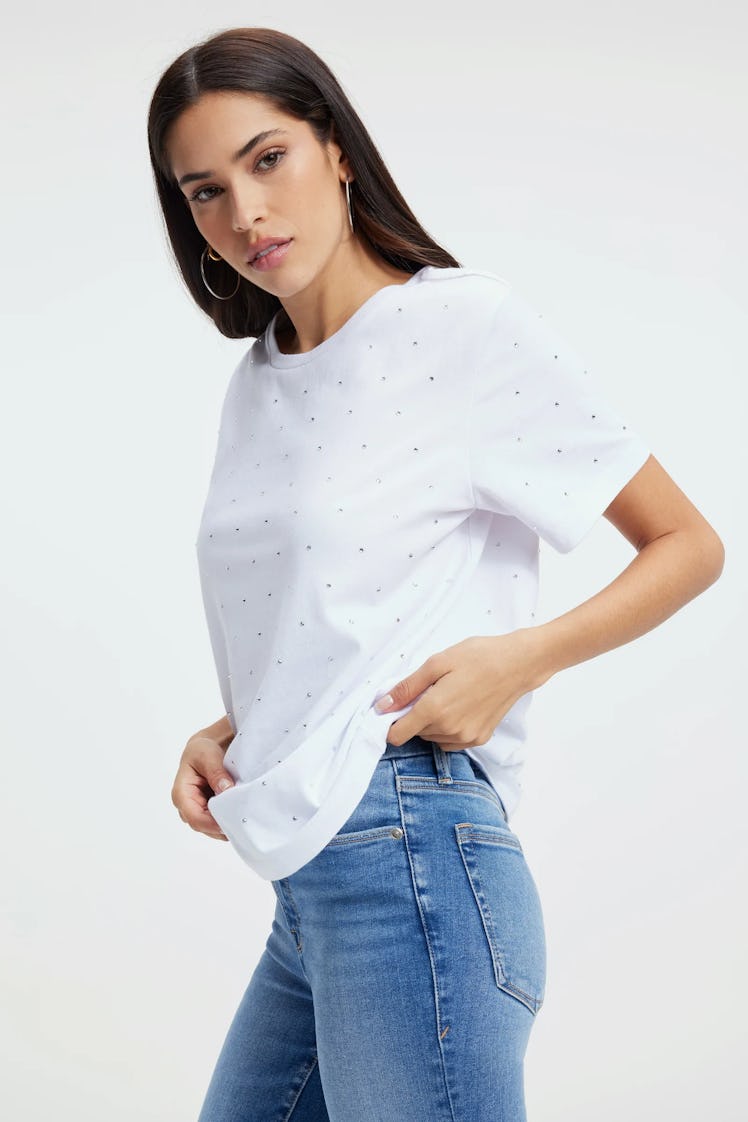 A model wears the diamond studded tee from Khloe K's Good American Zodiac Collection, under $100. 