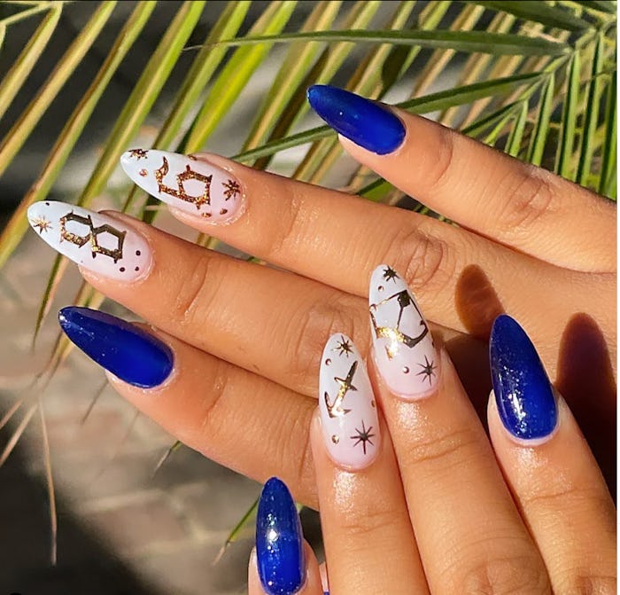Royal blue and white nails with golden Sagittarius sign nail designs