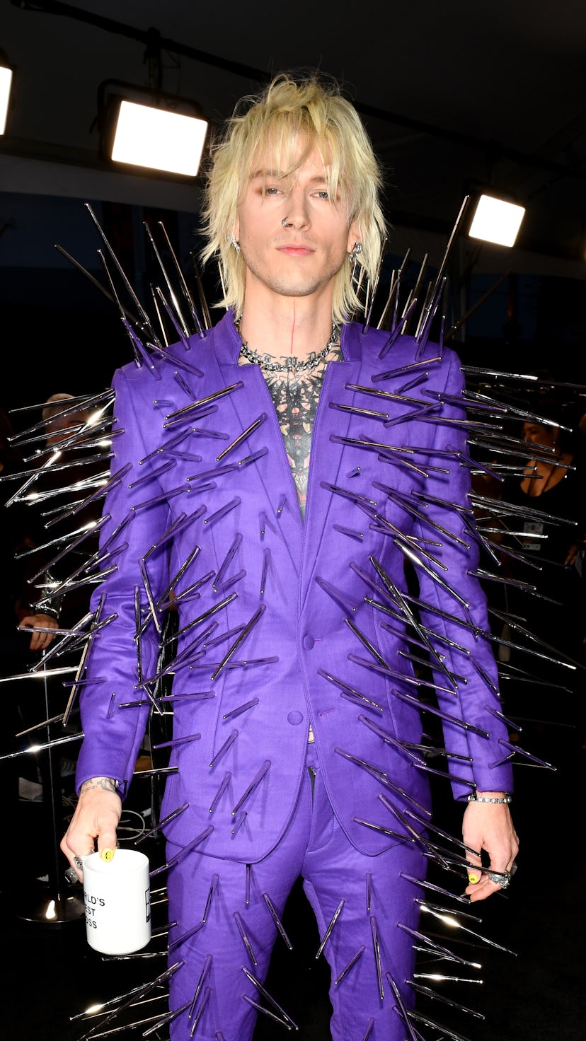 Machine Gun Kelly at the 2022 AMAs, wearing a spiked purple suit.