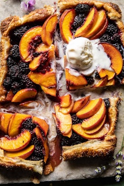Thanksgiving desserts that aren't pumpkin pie, like this blackberry peach galette topped with vanill...