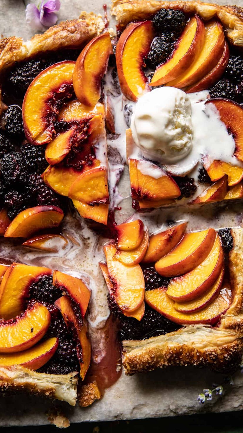 Thanksgiving desserts that aren't pumpkin pie, like this blackberry peach galette topped with vanill...