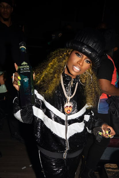 MIssy Elliott holds a Parton bottle. 