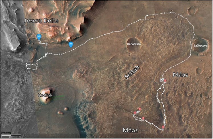 satellite view of rock formations on Mars, with a rover's path traced around them