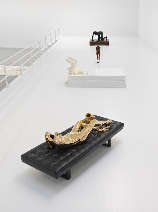 installation view of sculptures fo female nudes in a white gallery mezzanine