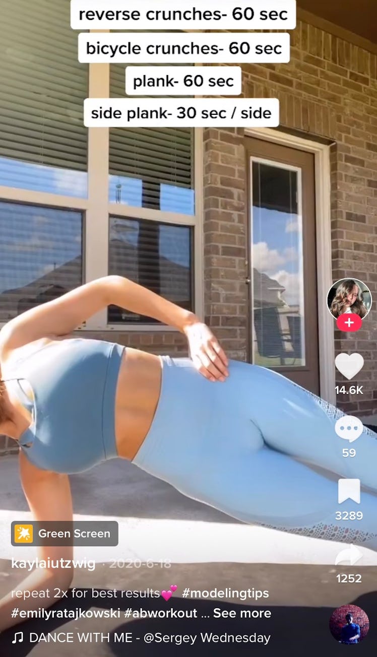 A TikToker does side planks as part of Emily Ratajkowski's ab workout from TikTok. 