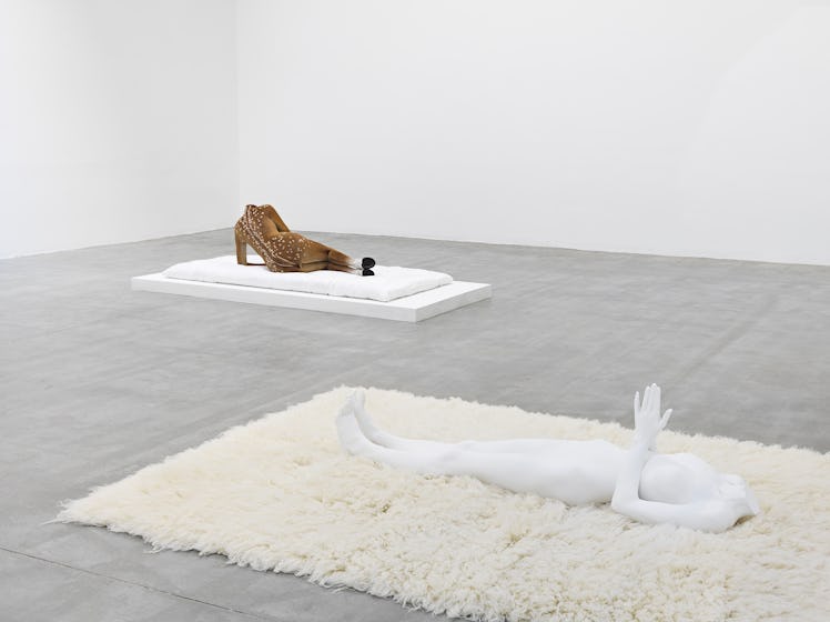 sculptures of female nude figures in a gallery space