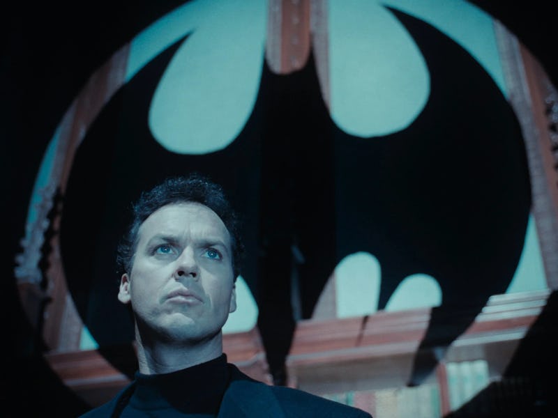 Bruce Wayne (Michael Keaton) stands beneath a Bat emblem in Tim Burton's Batman Returns