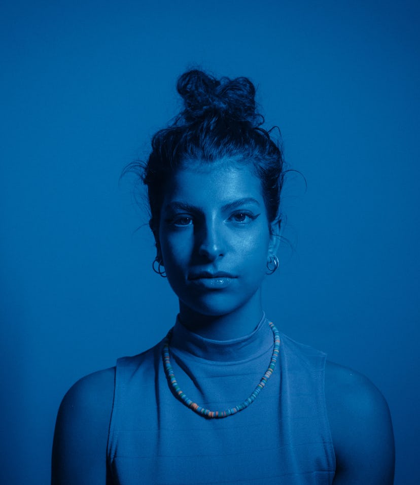 Young woman in blue lighting, symbolizing the eighth house in astrology.