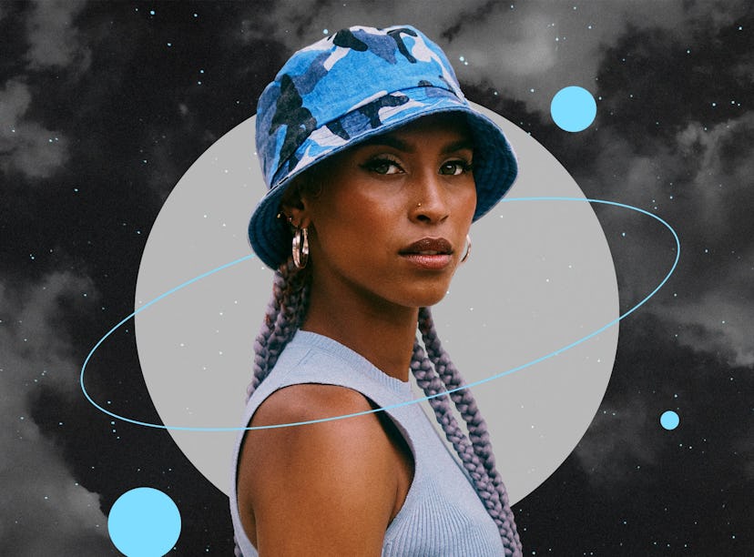 Young woman wearing a blue hat before reading her December 2022 horoscope.