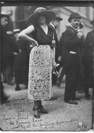 Woman wearing a skirt made from Fritz Rau & Co. chemical lace at the Grand Prix de Paris, Paris, 192...
