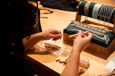 An artisan from the Brooklyn Lace Guild demonstrates different lacemaking techniques.