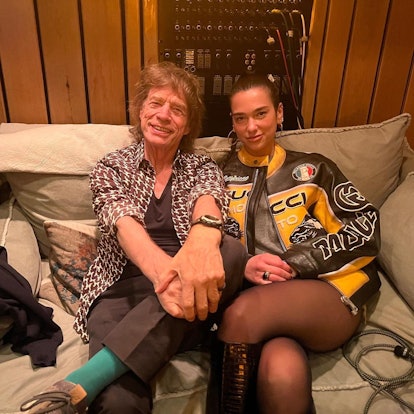 Dua Lipa and Mick Jagger smiling at the camera