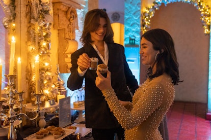A couple enjoys the themed snacks at the Harry Potter: A Yule Ball Celebration in Houston. 