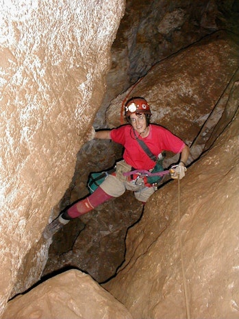 bat biologist in a cave doing research 