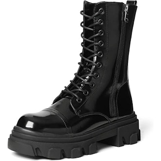 a pair of lug-sole combat boots in patent leather