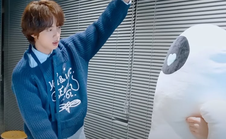 Jin reviews the Jin from BTS merch, which includes a "The Astronaut" body pillow. 