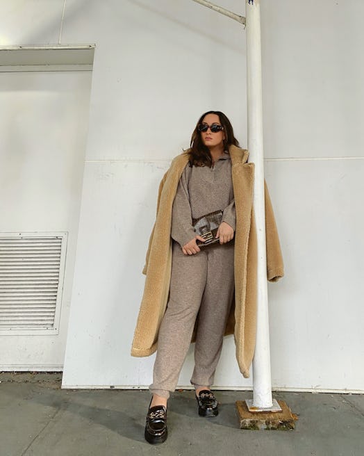 Model wears a Filoro cashmere sweatsuit, a sherpa jacket and Circus by Sam Edelman loafers.