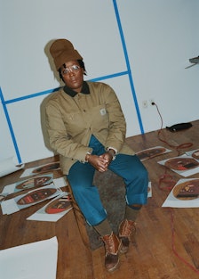 Nina Chanel Abney sits in her printmaking studio in Manhattan, New York amongst her works, spread ou...