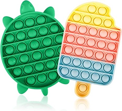 Two fidget poppers, shaped like a popsicle and a turtle, would be great fidget toys for kids.