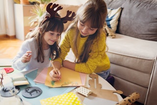 Sisters work on their Christmas list, a sign they still believe in Santa.