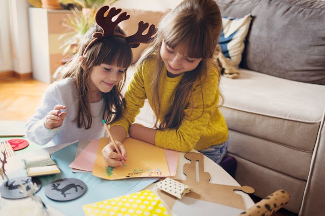 Sisters work on their Christmas list, a sign they still believe in Santa.