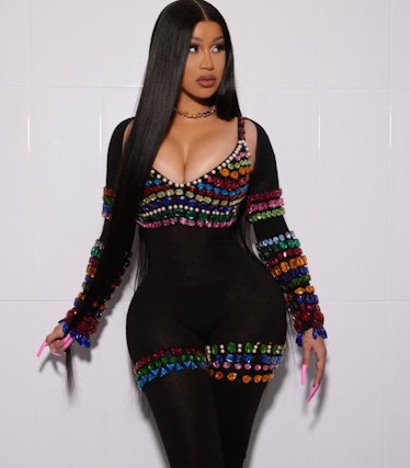 Cardi B long hair center part with jeweled outfit and pink nails