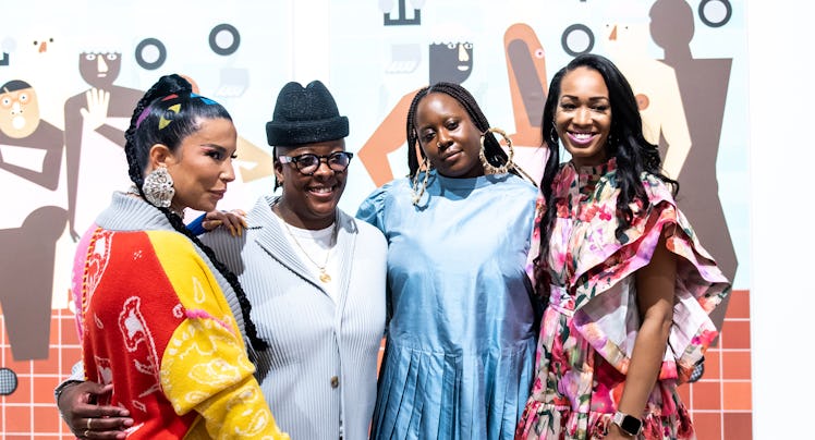 four women standing in an art gallery