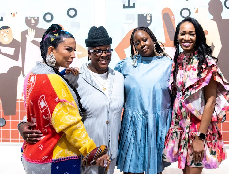 four women standing in an art gallery