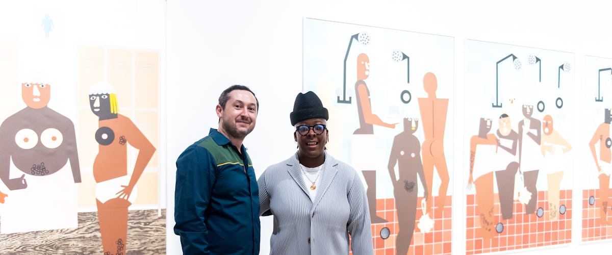a man and woman in front of paintings
