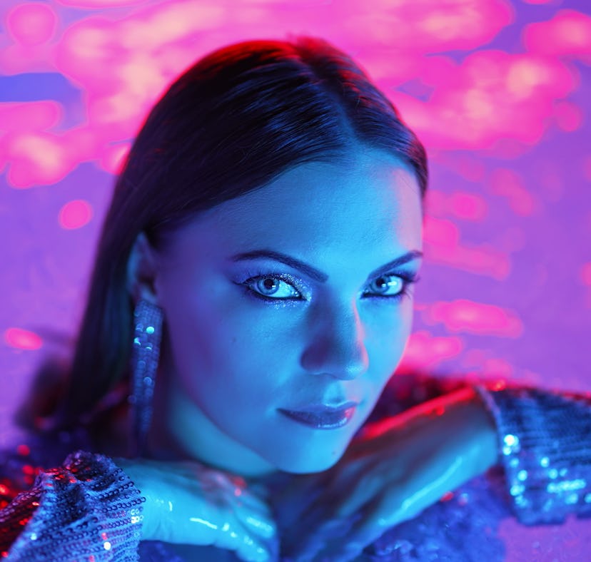 Young woman posing in a pool during the November 2022 full moon lunar eclipse.