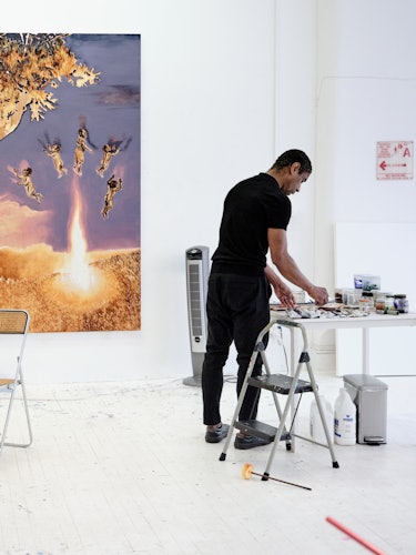 Antonio painting in his studio