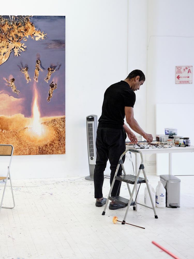 Antonio painting in his studio