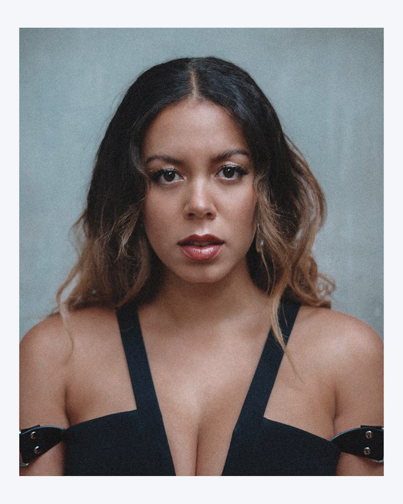 A portrait of Nicôle wearing a black dress