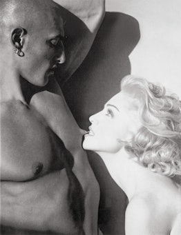 Madonna biting a man's nipple. 