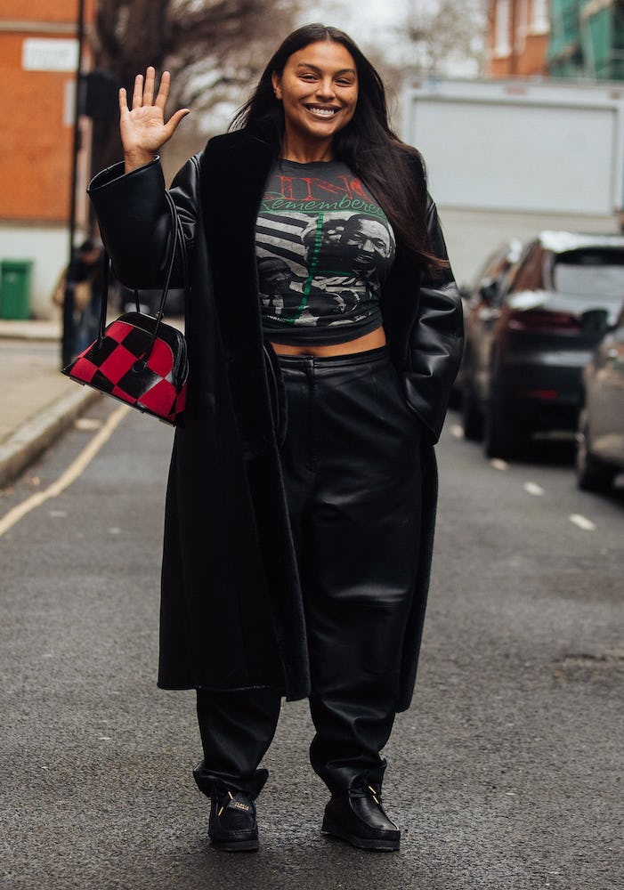Model Paloma Elsesser waves and wears a black leather trench, black Martin Luther King Jr. shirt, bl&hellip;